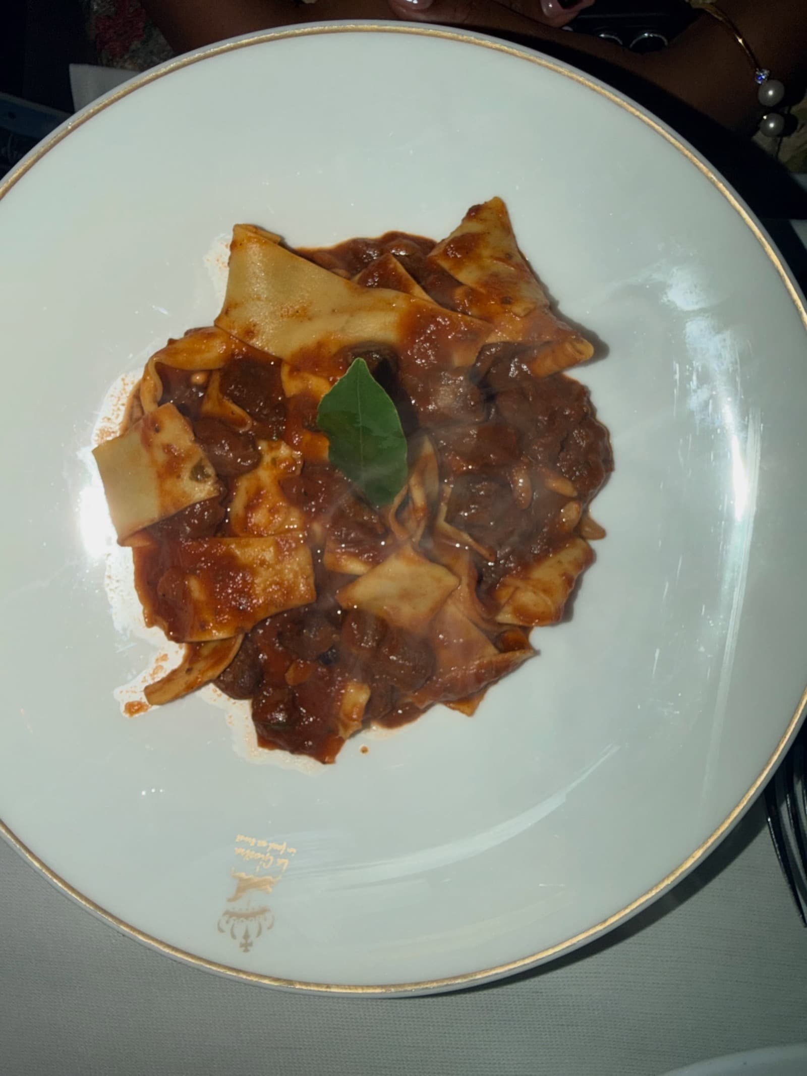 Pappardelle al ragù on the crested plate